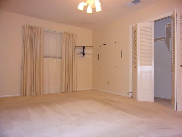 unfurnished bedroom with carpet, visible vents, and baseboards