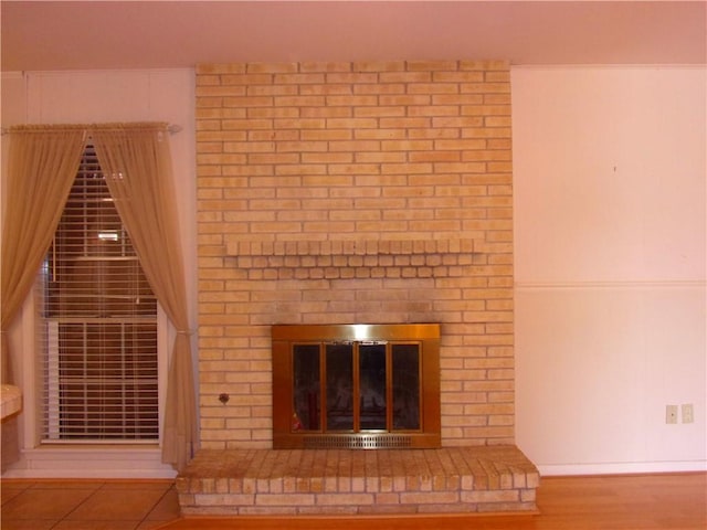 interior details featuring a fireplace and wood finished floors