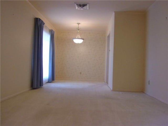 carpeted spare room with wallpapered walls, baseboards, and visible vents