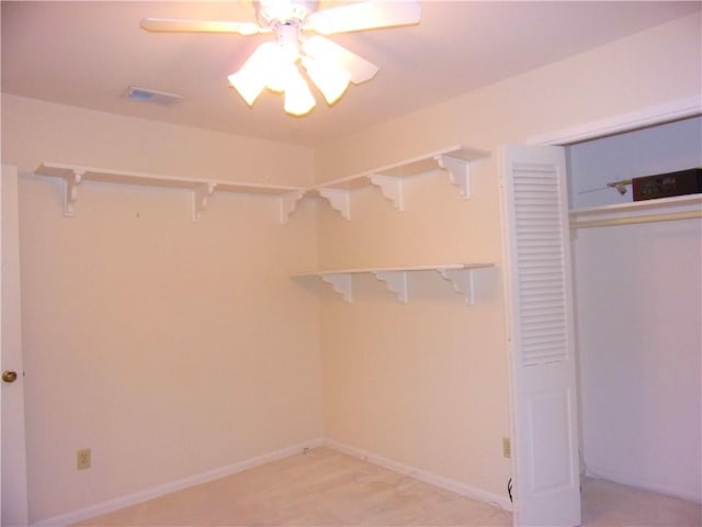 spacious closet with ceiling fan and visible vents