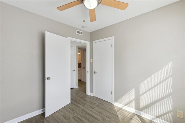 empty room with ceiling fan and hardwood / wood-style flooring