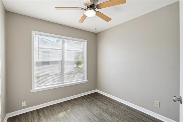 unfurnished room with ceiling fan and dark hardwood / wood-style flooring