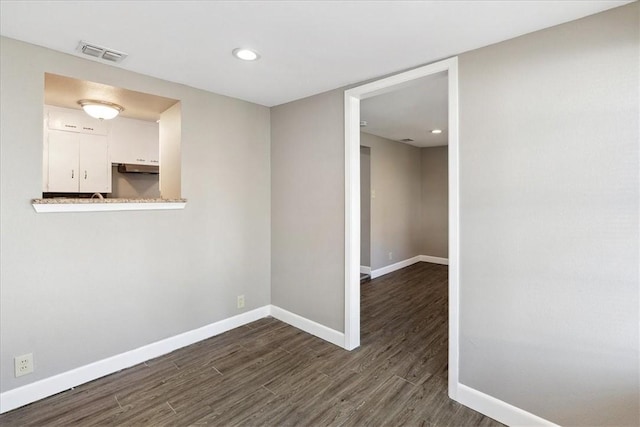 spare room featuring dark hardwood / wood-style flooring