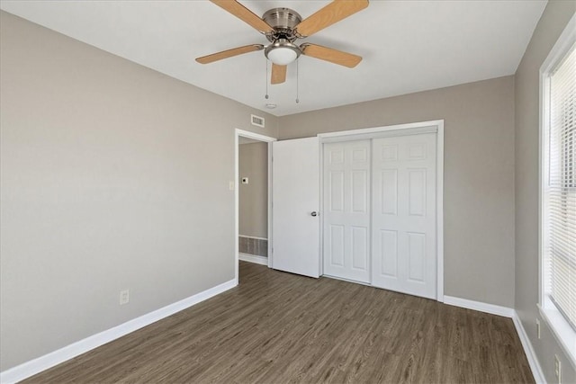 unfurnished bedroom featuring ceiling fan, a closet, and dark hardwood / wood-style floors