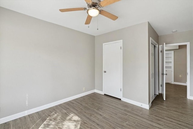 unfurnished room featuring dark hardwood / wood-style floors and ceiling fan