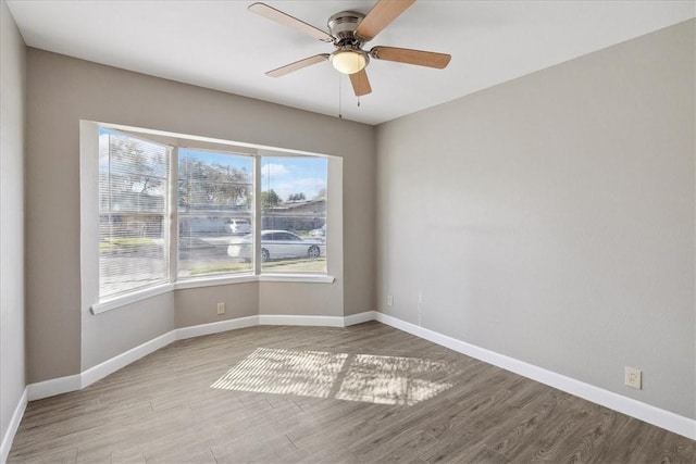 empty room with light hardwood / wood-style flooring and ceiling fan