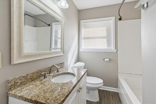 full bathroom with hardwood / wood-style floors, vanity, toilet, and tub / shower combination