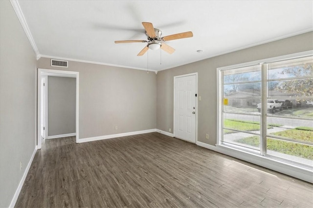 spare room with ceiling fan, dark hardwood / wood-style flooring, and ornamental molding