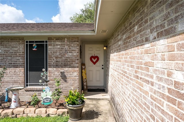 3713 Tripoli Dr, Corpus Christi, TX 78415 - view of exterior entry featuring brick siding and a shingled roof