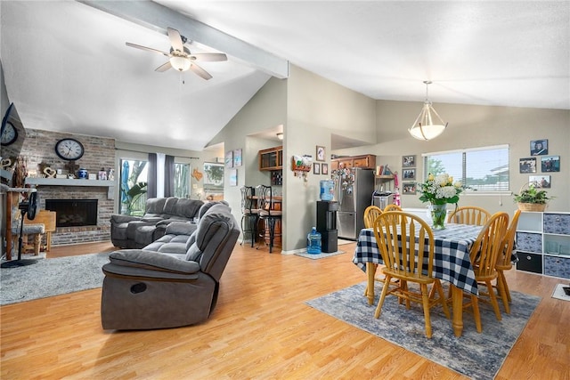 3713 Tripoli Dr, Corpus Christi, TX 78415 - dining area featuring healthy amount of natural light, a ceiling fan, light wood-style floors, beam ceiling, and a fireplace