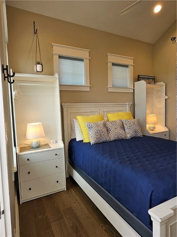 bedroom with dark hardwood / wood-style floors and ceiling fan