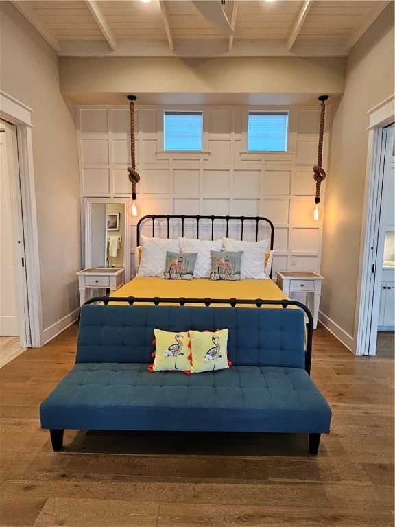 bedroom featuring wood-type flooring and wooden ceiling