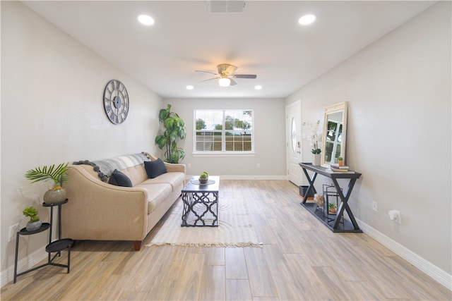 living room featuring light hardwood / wood-style floors and ceiling fan