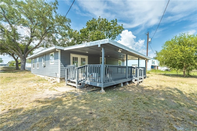 rear view of house featuring a deck