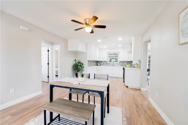 dining space with light wood-type flooring and ceiling fan