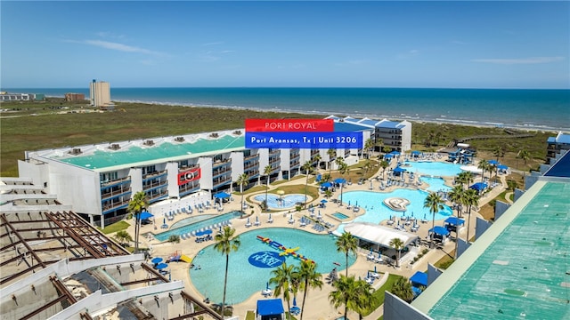 drone / aerial view featuring a beach view and a water view