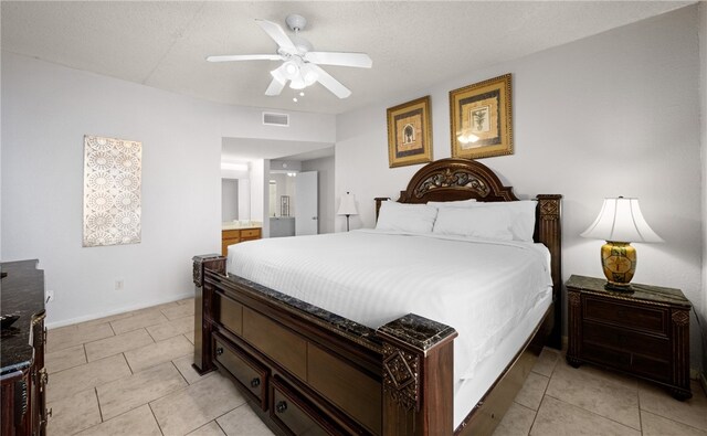 bedroom featuring light tile patterned floors, connected bathroom, a textured ceiling, and ceiling fan