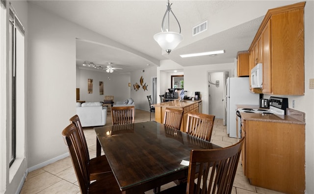 dining room with ceiling fan, light tile patterned floors, and a textured ceiling