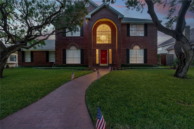 colonial-style house featuring a yard