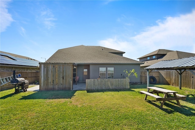 back of house featuring a lawn