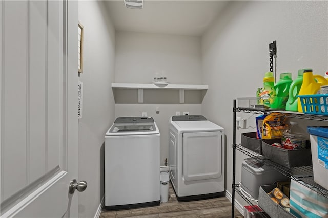 laundry room featuring washer and dryer and hardwood / wood-style flooring