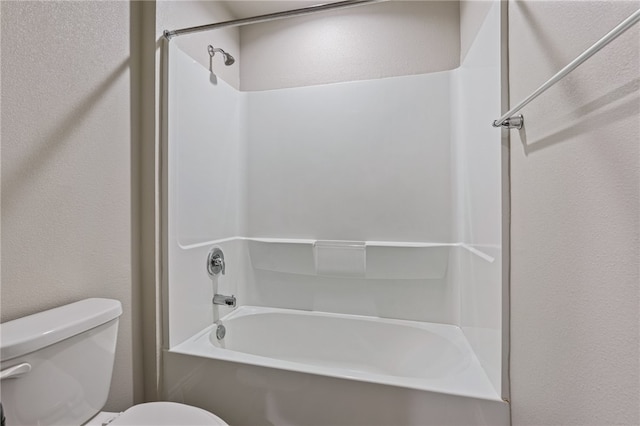 bathroom featuring shower / bath combination and toilet