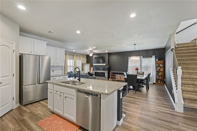 kitchen featuring white cabinets, a healthy amount of sunlight, and appliances with stainless steel finishes