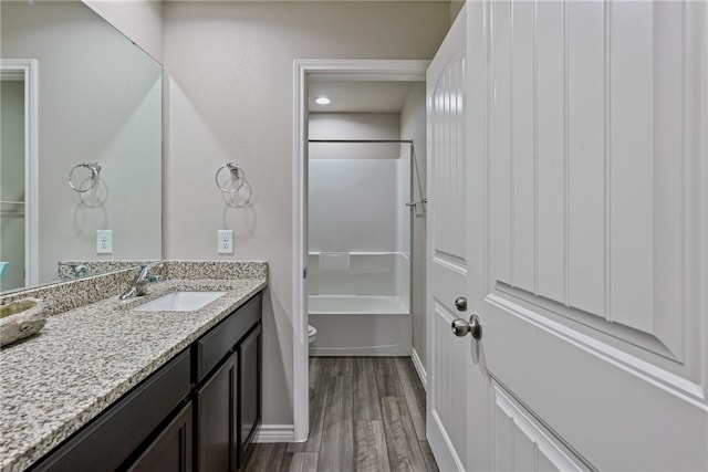 bathroom featuring vanity, toilet, and wood-type flooring