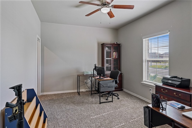 carpeted office featuring ceiling fan