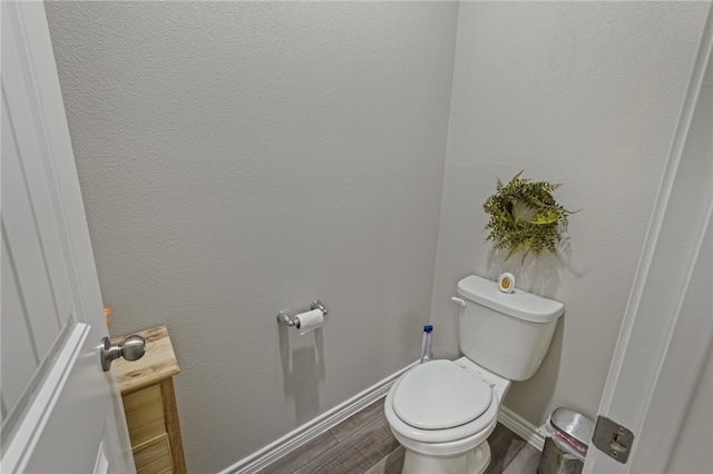 bathroom featuring hardwood / wood-style floors and toilet