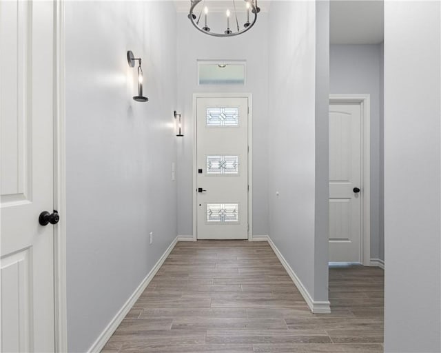 entryway with a notable chandelier and light wood-type flooring