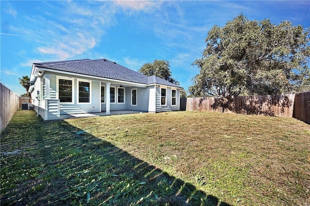 rear view of house featuring central AC, a patio area, and a lawn