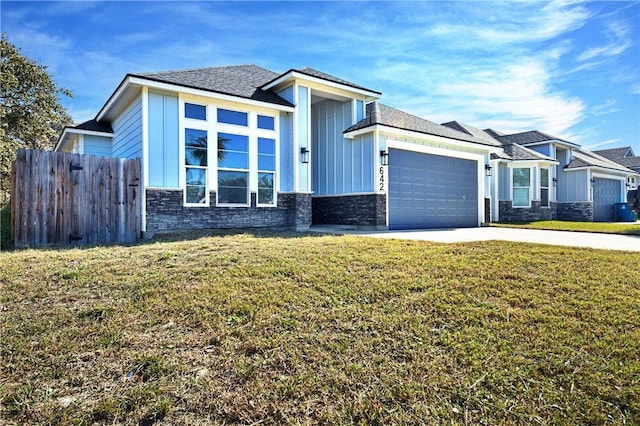 view of front of house with a garage and a front lawn