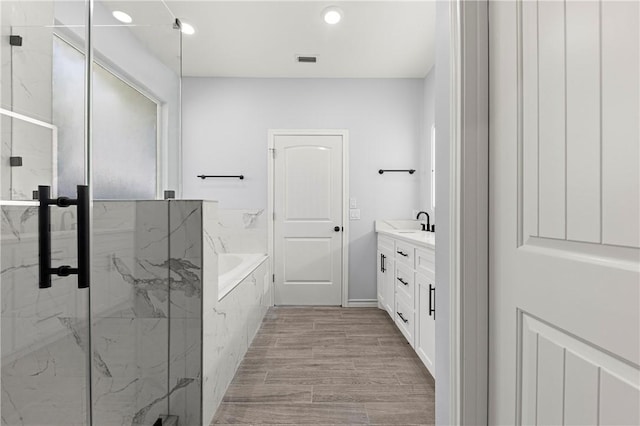 bathroom with vanity and separate shower and tub