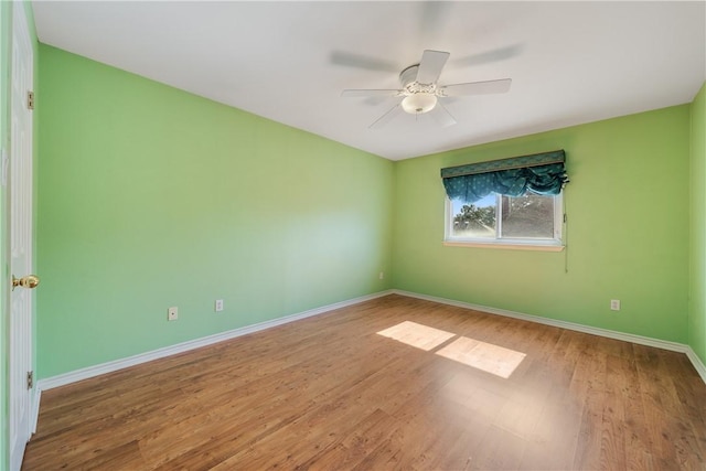 empty room featuring hardwood / wood-style flooring and ceiling fan