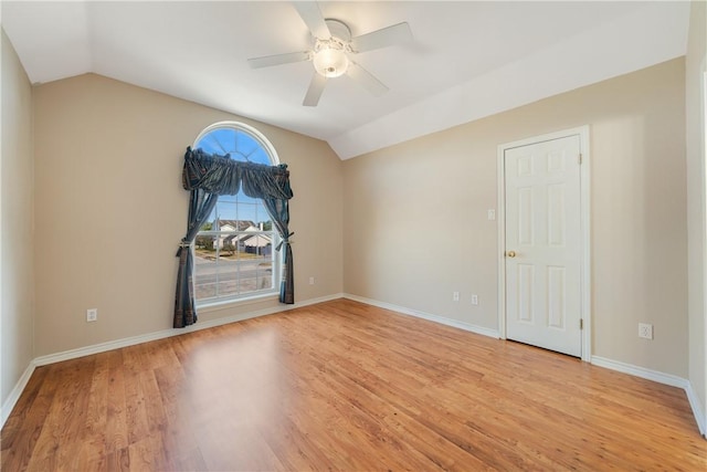 spare room featuring vaulted ceiling, ceiling fan, and light wood-type flooring