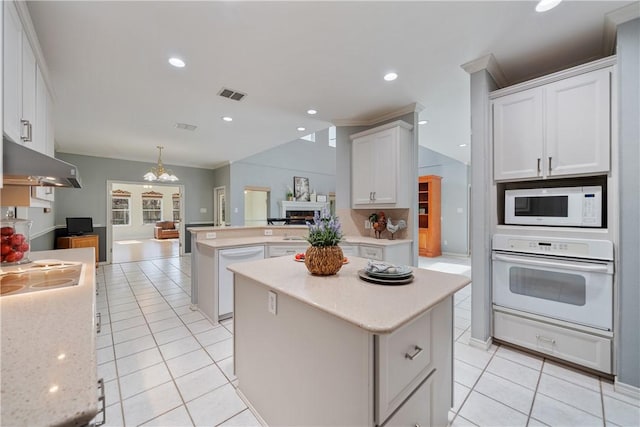 kitchen with white cabinetry, white appliances, pendant lighting, and a kitchen island