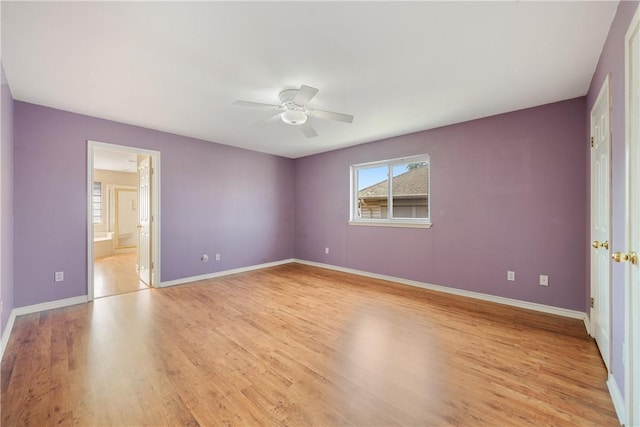 unfurnished bedroom with light wood-type flooring, connected bathroom, and ceiling fan