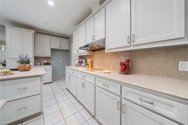 kitchen with tasteful backsplash, electric stovetop, light tile patterned flooring, and white cabinets