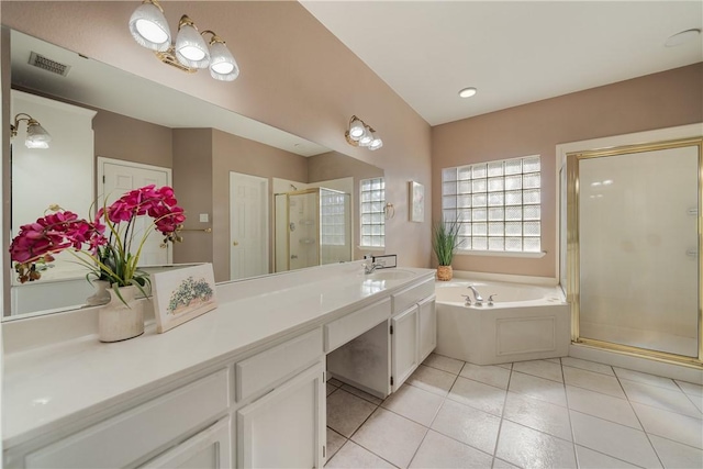 bathroom featuring vanity, tile patterned floors, and plus walk in shower