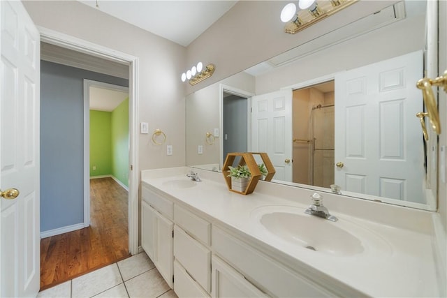 bathroom with vanity, tile patterned flooring, and a shower