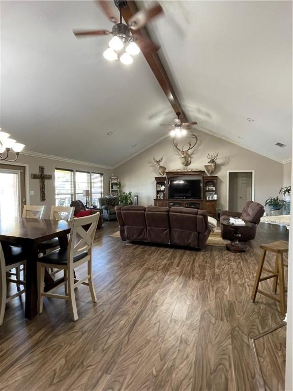 dining space featuring plenty of natural light, wood finished floors, and ceiling fan with notable chandelier