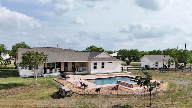 view of pool featuring fence, a yard, and a porch