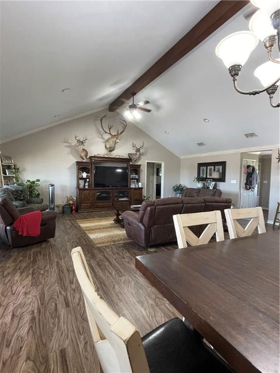 dining space with visible vents, vaulted ceiling with beams, wood finished floors, and ceiling fan with notable chandelier