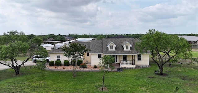 cape cod home with a front lawn, covered porch, and fence
