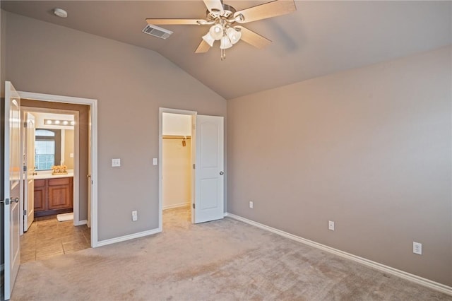 7437 Long S Dr, Corpus Christi, TX 78414 - unfurnished bedroom with a walk in closet, light carpet, vaulted ceiling, baseboards, and a ceiling fan