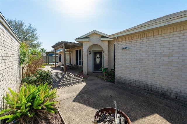 7437 Long S Dr, Corpus Christi, TX 78414 - entrance to property featuring a pergola, a patio area, brick siding, and fence