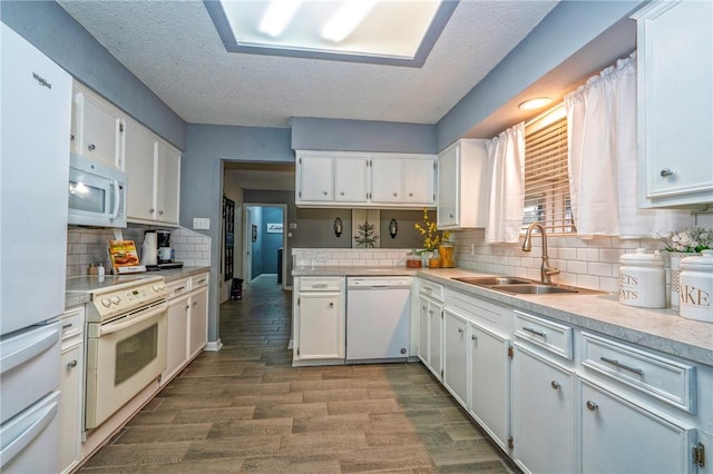 4318 Pecan Bayou Ct, Corpus Christi, TX 78410 - kitchen with sink, white appliances, white cabinetry, backsplash, and light wood-type flooring