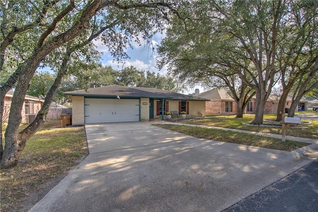 ranch-style house featuring a garage and a front lawn