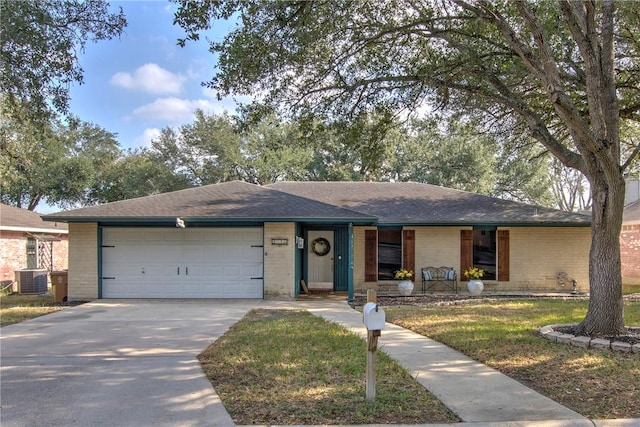 single story home with a garage, central air condition unit, and a front lawn